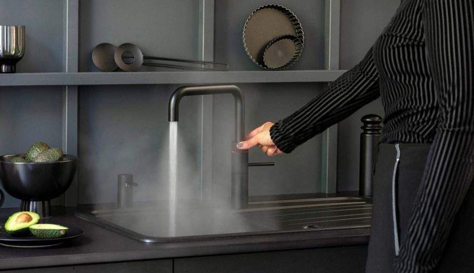 Quooker boiling water tap running in a modern kitchen sink