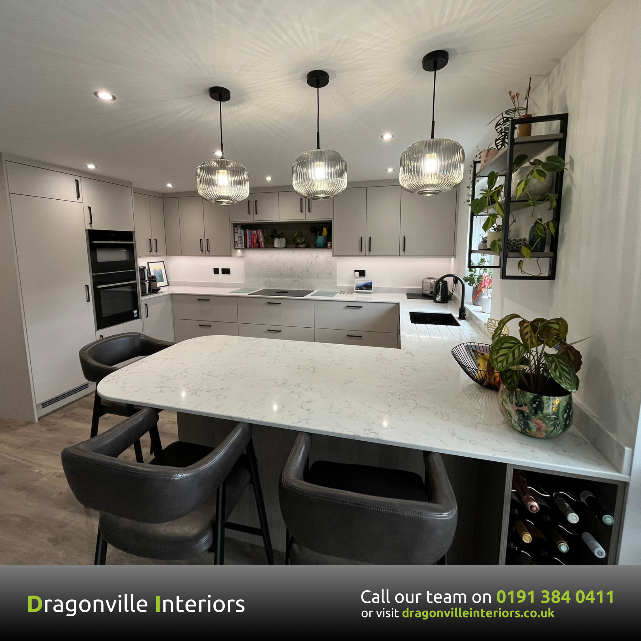 Bespoke fitted kitchen in Durham with grey cabinetry, quartz island and pendant lighting by Dragonville Interiors