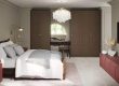 Small bedroom design with fitted wardrobes, dressing area and neutral tones creating a calm and spacious feel