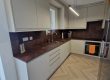 Matt Taupe bespoke kitchen in Durham with ceramic rust compact laminate worktops and full-height splashbacks